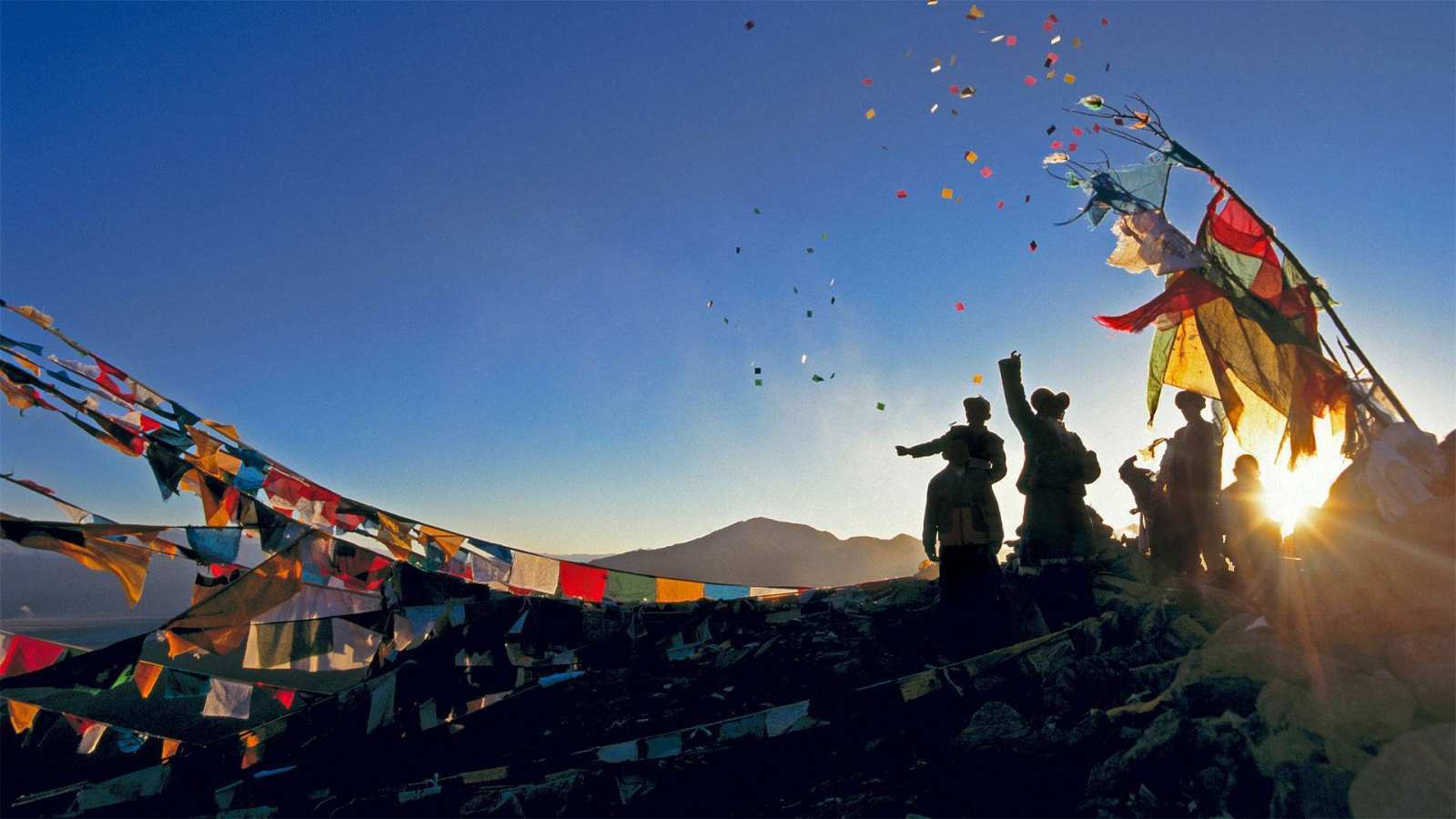 必应壁纸 2020年2月24日 朝圣者将风马旗扔向甘登寺上方的空中为新年祈福，中国西藏